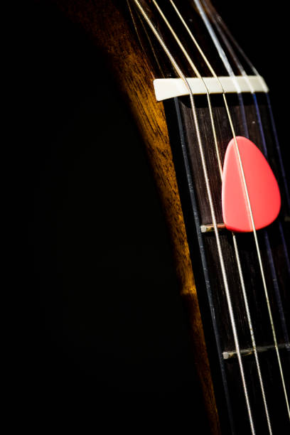 istock pink pick on guitar neck 1045951202