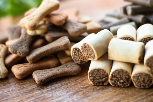istock Dog tasty colored biscuits on wooden background, snacks for dogs 1045953532