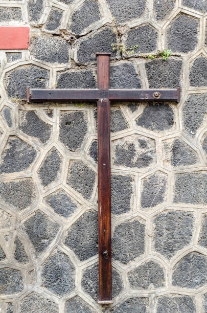 istock wooden christian cross on a grey stone wall 1045953934