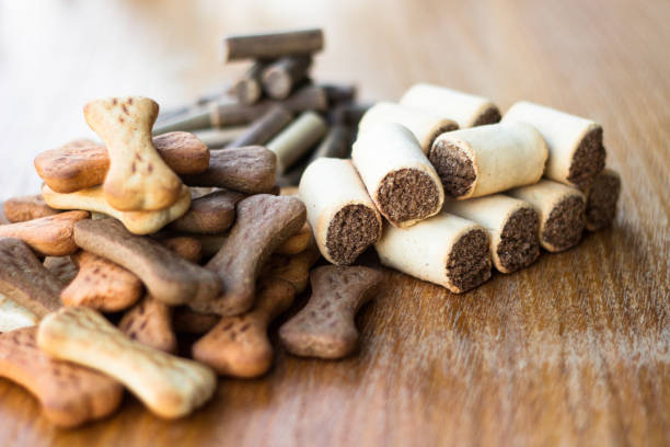 istock Dog tasty colored biscuits on wooden background, snacks for dogs 1045954232