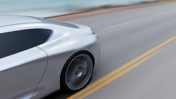 istock red car driving on a road by sea 1045956966