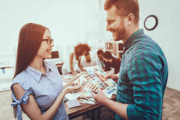 istock Cooperation. Guy and Girl. Colors for Design. 1045960484