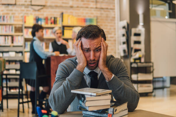istock Tired man looking at his books 1045971470