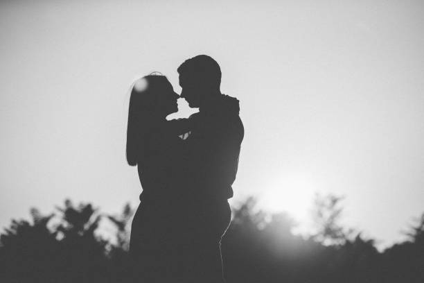 Young couple in love in the nature during the sunset