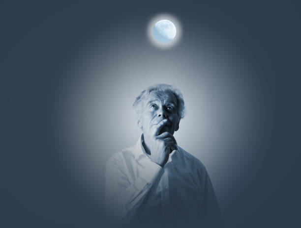 istock Old man in white and moon. Full moon and sleeplessness concept. 1045975654