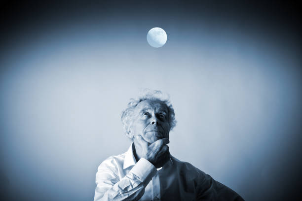 istock Old man in white and moon. Full moon and sleeplessness concept. 1045975656