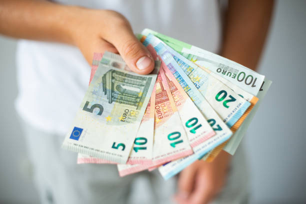 Hand holding euro banknotes stock photo