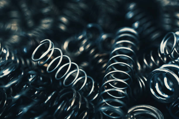 Coiled springs background Heap of coiled springs of various size. coiled spring stock pictures, royalty-free photos & images