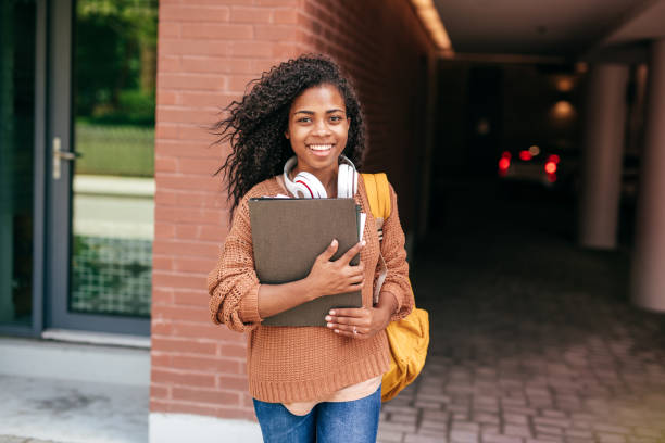 istock International student with backpack, headphones and digital gadgets 1045983016