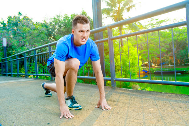 istock Young asian runner man in ready position to run 1045983186