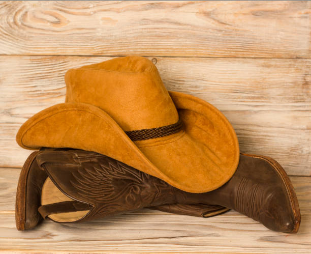 istock American West cowboy boots and hat on wood texture background 1045986470