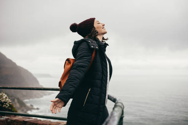 istock Woman enjoying the climate on mountain top 1045987576