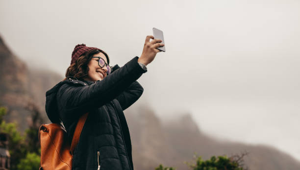 istock Woman on winter vacation taking a selfie 1045989008