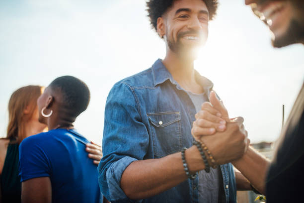 istock Cheerful young people enjoying at party on rooftop 1045993540