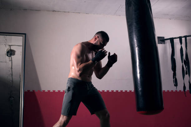 istock Young man boxing workout in an old building 1045993616