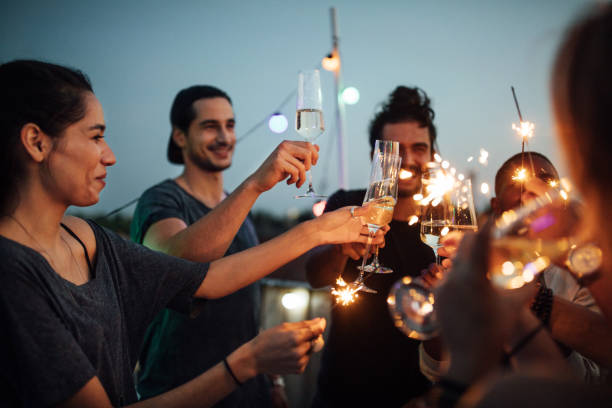 istock Multi-ethnic friends enjoying at rooftop party 1045993696