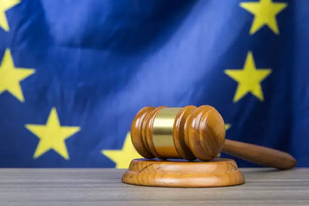 Photo of Court gavel with European Union flag in the background