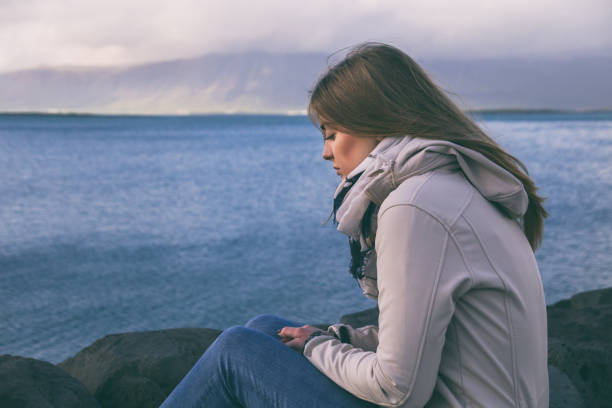 istock Sad woman by the sea 1045996828