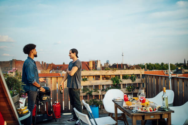 istock Friends chatting at barbecue party on rooftop 1045997054