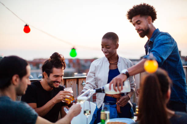 istock Multi-ethnic friends enjoying drinks at barbecue reunion party 1046000472