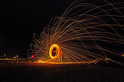 Dramatic firewheel created by young man whirling a sparkler in a circle