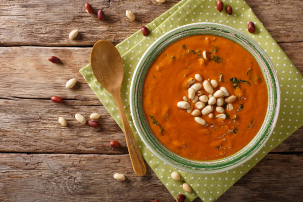 istock Peanut puree soup with greens close-up on a table. horizontal top view 1046016396