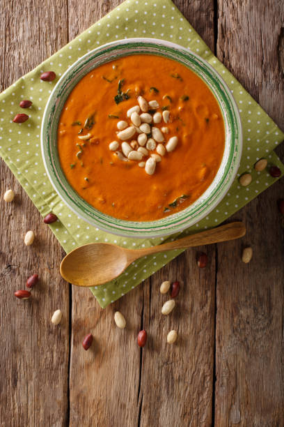 istock Peanut puree soup with greens close-up on a table. Vertical top view 1046016514