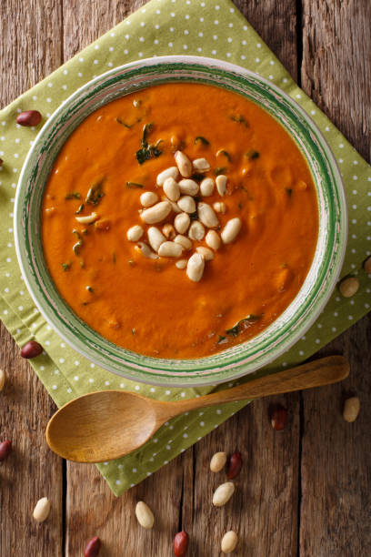istock Vegetarian West African Peanut Soup close-up in a plate. Vertical top view 1046016740