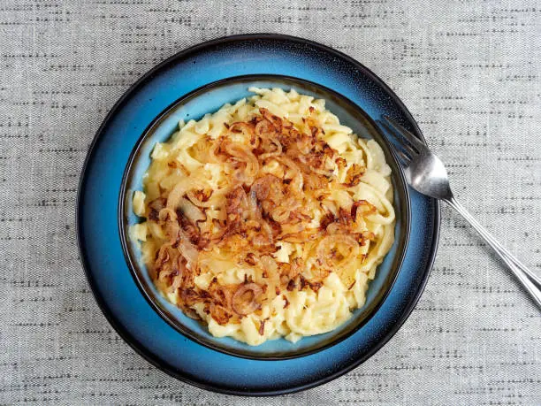 Traditional Swabian "Käsespätzle" - a dish of egg and flour noodles with grated cheese and fried onions. Also spelled kaesespaetzle