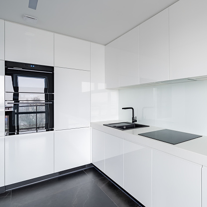 White Kitchen With Black Accessories Stock Photo - Download Image