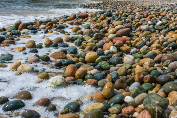 istock Wet, colorful, big pebbles on Mediterranean beach. Texture, background concept. 1046031110