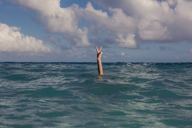 istock Vacation Peace Sign In Ocean Photo 1046031498