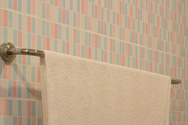 istock towel hanging on metal bar fixed on the wall in restroom 1046046758