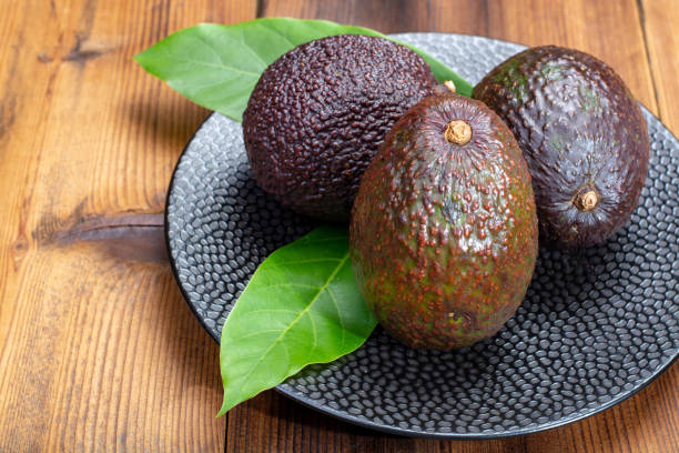 Ripe organic healthy hass avocado, new harvest Ripe organic healthy hass avocado, new harvest  close up hass avocado stock pictures, royalty-free photos & images