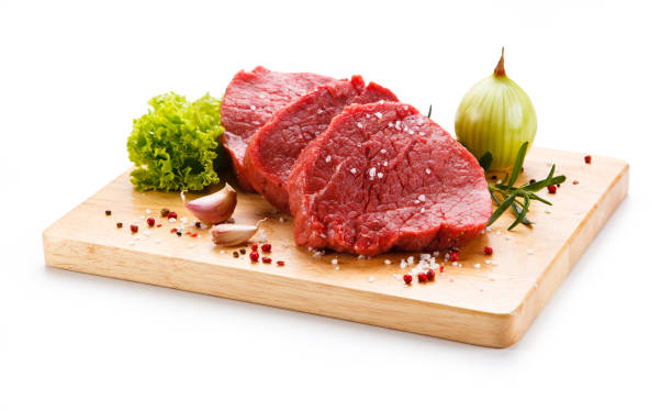 istock Raw beef on cutting board and vegetables 1046050356