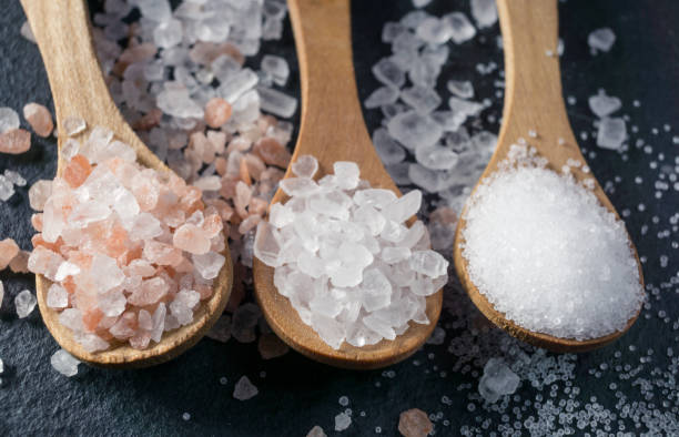 istock Different types of salt. Top view on three wooden spoons 1046053904
