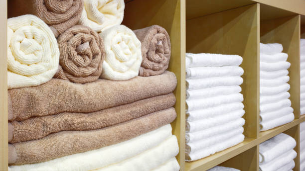 istock White and brown beige Towels Folded and Stacked on a Shelf 1046056170
