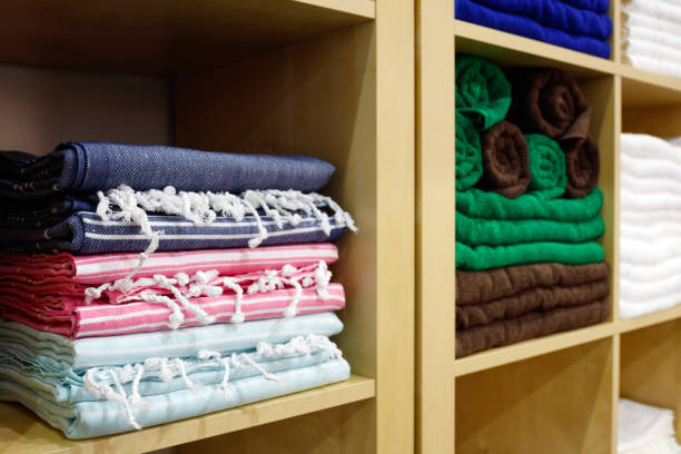 istock Fresh White and colorful Hotel Towels Folded and Stacked on a Shelf 1046056408