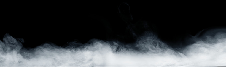 Panoramic view of the abstract fog or smoke move on black background. White cloudiness, mist or smog background.