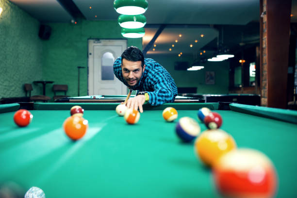 istock Man playing billiard in a pool hall. 1046068142