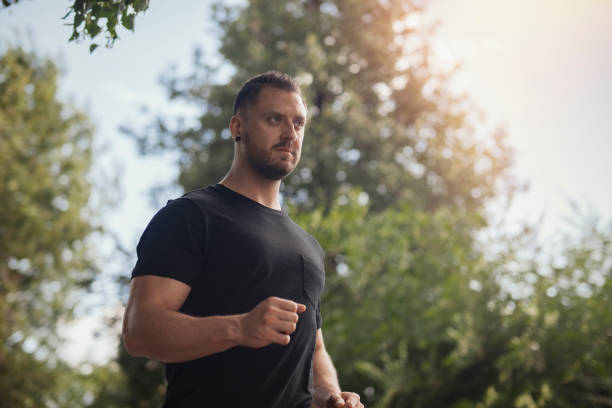istock Young man running outdoors in the park. 1046078312