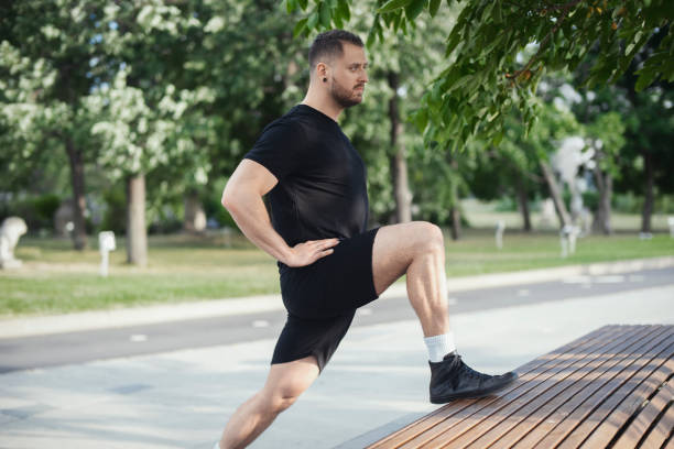 istock Fitness man doing lunges leg exercise outdoors. 1046078350