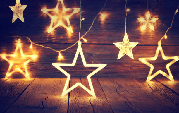 istock Christmas light stars vintage rustic wood 1046081190