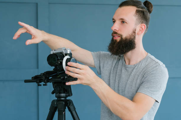 istock cameraman instruction pointing finger directing 1046086370