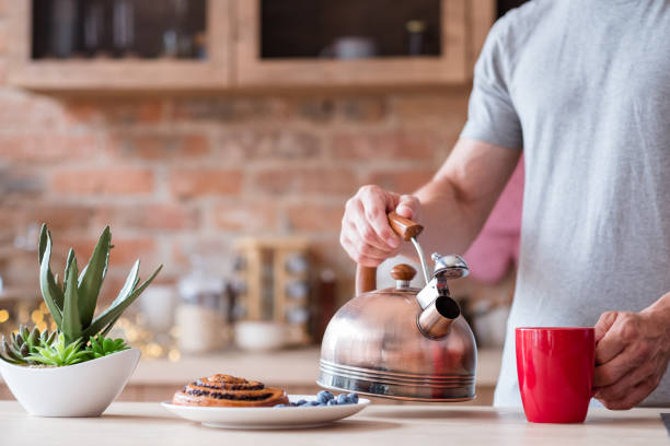istock traditional breakfast food kettle tea red mug man 1046086384
