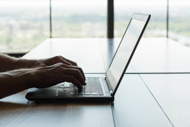 istock freelance work remote job laptop man hands typing 1046086942
