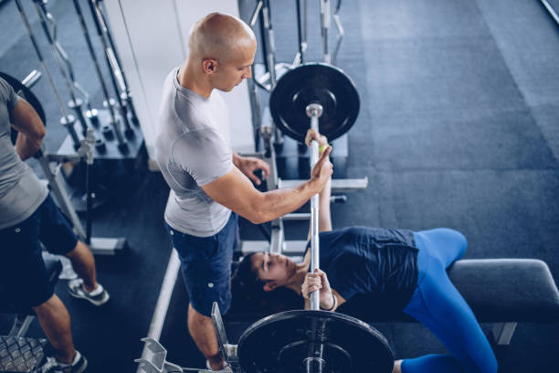 istock Personal trainer with woman in gym 1046095966