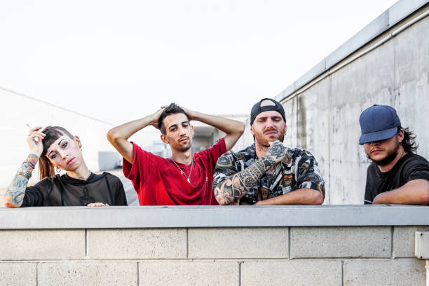 istock group of rappers posing leaning against the wall 1046095972