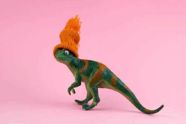 Plastic mass produced toy dinosaurs attacking technology. This a concept image for 'Don't Be A Dinosaur' or a Luddite theme.