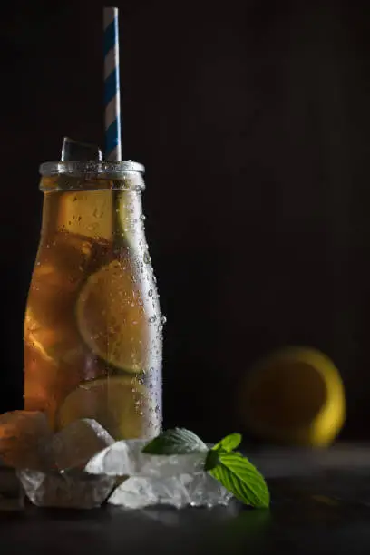 Photo of homemade lemonade ice tea with lemon and ice